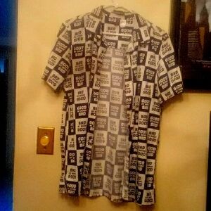 Button down tee shirt with collar and slits on eac side saying bad at being good